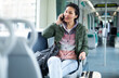 © JackF - Oriental woman talking on a mobile phone while riding a tram