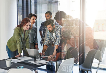 Aufkleber - Bringing fresh ideas to the table. Shot of a group of colleagues working together on a laptop in an office.