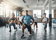 © Delmaine Donson/peopleimages.com - Every step taken towards fitness pays off. Shot of a group of young people doing lunges together during their workout in a gym.