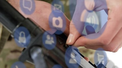 Poster - Animation of technology icons over hands of caucasian male soldier with weapon