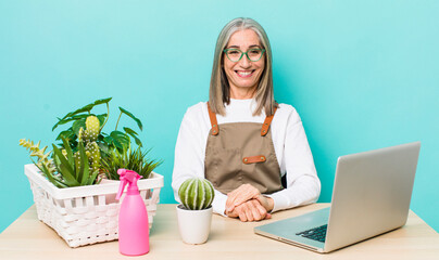 Wall Mural - senior gray hair woman looking happy and pleasantly surprised. gardener and plants concept