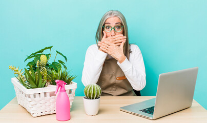 Wall Mural - senior gray hair woman covering mouth with hands with a shocked. gardener and plants concept