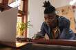 © Wavebreak Media - African american young craftsman using laptop at table in leather workshop