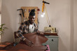 © Wavebreak Media - Smiling african american young craftsman checking leather quality while working in workshop