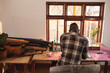 © Wavebreak Media - Rear view of african american young craftsman working at table in workshop
