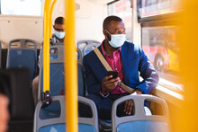 African American Businessman Holding Smartphone Sitting On The Bus On The Go To Office