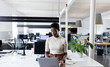 © Wavebreak Media - African-american businesswoman working on laptop in creative office