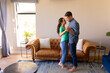 © Wavebreak Media - Caucasian couple dancing together in the living room at home