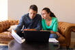 © Wavebreak Media - Caucasian couple using laptop and calculating finances together at home