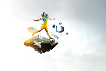 Wall Mural - Young woman jumping in the air