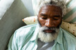 © Wavebreak Media - High angle view of retired african american senior man with white beard sleeping on sofa at home