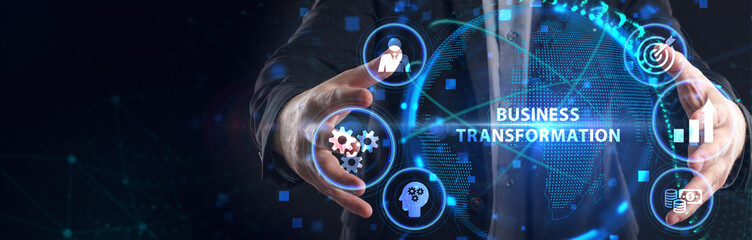 The concept of business, technology, the Internet and the network. A young entrepreneur working on a virtual screen of the future and sees the inscription: Business transformation