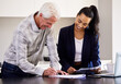 © Nina Lawrenson/peopleimages.com - So I just sign right here. Cropped shot of an attractive young female broker going over some paperwork with a senior male client.