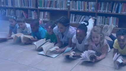 Sticker - Animation of light spots over diverse schoolchildren and teacher reading books in library