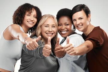 Canvas Print - Nothing but good vibes here. Shot of a diverse group of women standing together in the studio and showing a thumbs up.