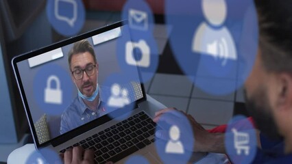 Poster - Animation of media icons over caucasian man with face mask having laptop video call