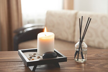 Scented Candles And Aroma Incense Sticks On Wooden Table In Living Room. Aromatherapy, Home Fragrance. Concept Of Home Relaxation And Anti Stress.