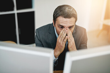 Canvas Print - I messed up so badly. Shot of a mature businessman looking stressed out at his desk.