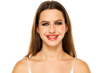 Wall Mural - Beautiful smiling woman with make up and long hair on a white background