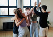 © pressmaster - Group of contemporary teenage friends giving hugs and high five to each other while celebrating their victory in vogue dance performance