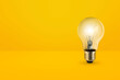 light bulbs on bright yellow background in pastel colors simple concept bright idea ideas isolated lamps
