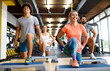 © NDABCREATIVITY - Portrait of happy fit people, friends exercising in gym together. Sport people workout concept
