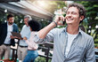 © Jadon B/peopleimages.com - Youve given me the best news ever. Shot of a businessman talking on a cellphone outside with his colleagues in the background.