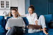 © shunevich - Image of successful young couple man and woman working on laptops together while sitting on coach at home. Happy spouses in love have success in new project with happiness and good emotion