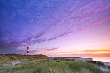 Wall Mural - beautiful sunset in the sandy dunes on the lighthouse