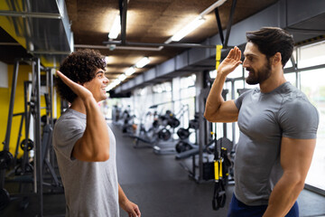 Portrait of happy fit group of people working out in gym together