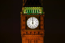 Big Ben Of The Houses Of Parliament London England UK At Night Striking Midnight On New Year's Eve On Westminster Bridge Which Is A Popular City Landmark, Stock Photo With Copy Space