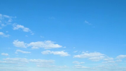 Wall Mural - Calm background with sky and white, slowly moving clouds. A simple blue background on the theme of nature, weather and peaceful enlightenment.