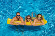 © Sunny studio - Happy family playing in outdoor pool