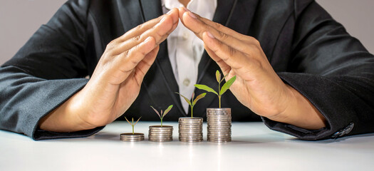 trees growing on a pile of coins in the hand of a middle-aged man. Retirement Financial Planning Ideas saving money and cash and investment to create financial stability after retirement