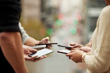 Sticker - Staying connected to stay informed. Closeup shot of a group of unrecognisable people using their cellphones in synchronicity.