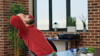 Wall Mural - executive manager taking break after working on business strategy, relaxing at desk on timeout. plea
