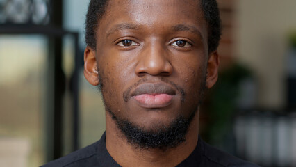 Portrait of african american person smiling and looking at camera, expressing happiness and positive emotions. Young man with authentic smile and white teeth feeling happy and cheerful.