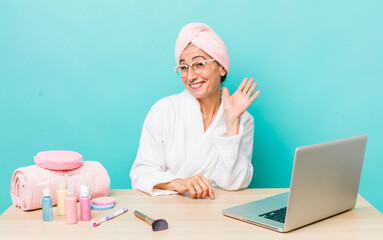 Wall Mural - senior gray hair woman smiling happily, waving hand, welcoming and greeting you.  skin care and shower concept