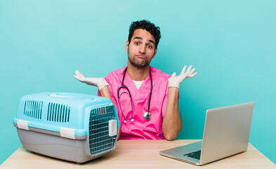 Wall Mural - hispanic handsome man feeling puzzled and confused and doubting. veterinarian concept