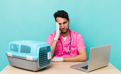 Wall Mural - hispanic handsome man feeling bored, frustrated and sleepy after a tiresome. veterinarian concept