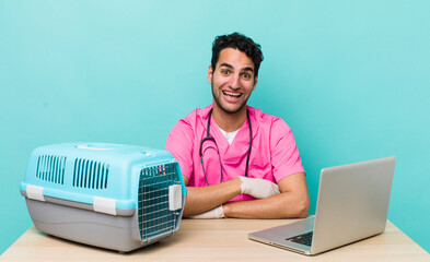 Wall Mural - hispanic handsome man looking happy and pleasantly surprised. veterinarian concept