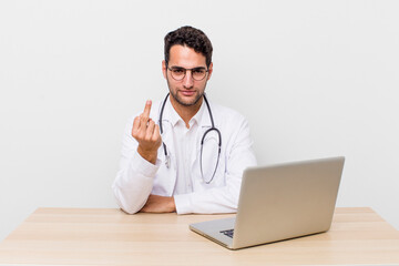 Wall Mural - hispanic handsome man feeling angry, annoyed, rebellious and aggressive. physician concept