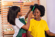 african hairstylist working on a lady's hair