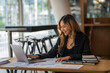 © crizzystudio - Asian businesswoman sitting working on laptop in office. tax, accounting, financial concept