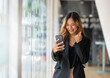© crizzystudio - Asian businesswoman using smartphone for video call working at office desk