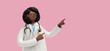 © NeoLeo - 3d render. African woman doctor in glasses, shows direction with finger, healthcare professional. Black female cartoon character isolated on pink background. Medical illustration
