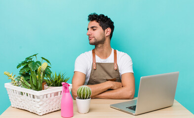 Sticker - hispanic handsome man on profile view thinking, imagining or daydreaming. garden and plants concept