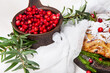 Delicious cranberry pie with fresh cranberries and herbs for Christmas on wooden plate