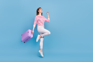 Poster - Full length profile photo of energetic overjoyed lady look empty space hold bag isolated on blue color background