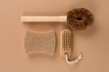 Wall Mural - Set of natural household cleaning products - bamboo brushes and organic dishcloth on beige background. Green cleaning concept